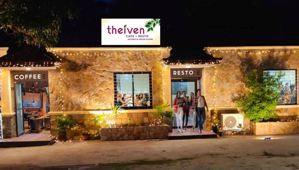Theiven Cafe storefront at night